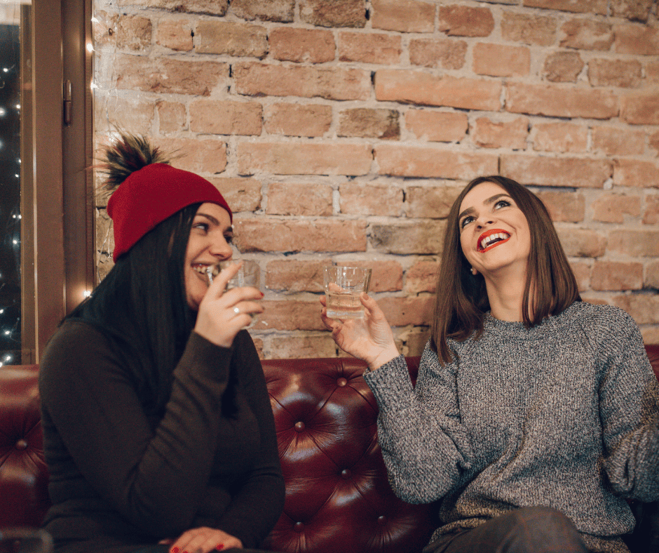 two women enjoying a whiskey listening to jazz